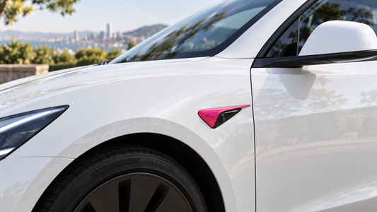 Beet purple HW4 side camera cover installed around an unobstructed front-fender camera on a white Tesla Model 3 Highland