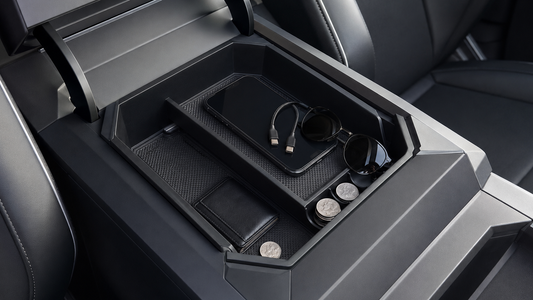 Black two-tier center console organizer installed in a Tesla Cybertruck with everyday essentials arranged in both storage levels