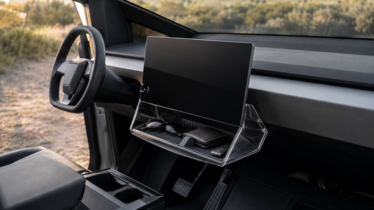 Cybertruck under-screen storage box holding sunglasses, a wallet, and a key fob