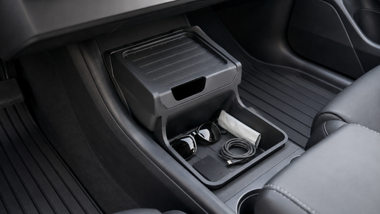 Black TPE lower center console organizer holding everyday items in a 2025–2026 Model Y Juniper Standard