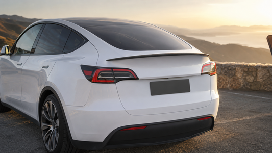 Matte real carbon fiber rear spoiler installed on a white 2020–2024 Model Y