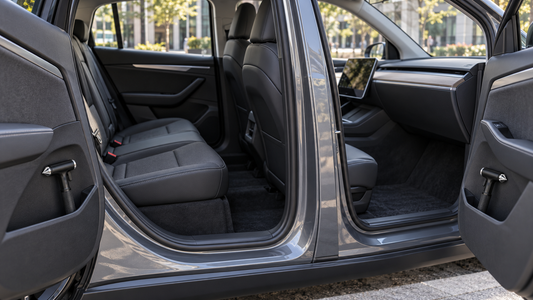 Two black car escape tools stored in separate front and rear door pockets of a clean rideshare vehicle
