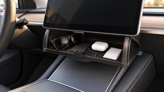 Black under-screen storage box holding sunglasses, a key card, earbuds, and a parking receipt