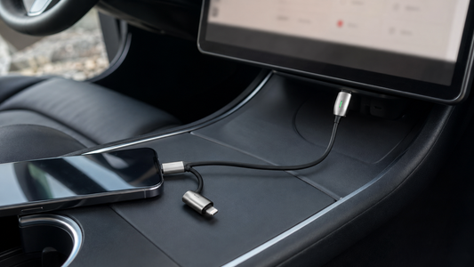 Tesheer 2-in-1 USB-C and Lightning-compatible charging cable routed through a parked Tesla center console