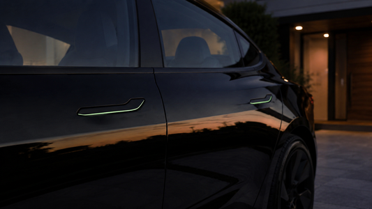 Black Tesla Model 3 at dusk with black and green fluorescent resin stickers on two flush door handles