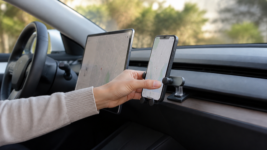 Tesla gravity phone mount holding a smartphone inside a parked Model 3 or Model Y