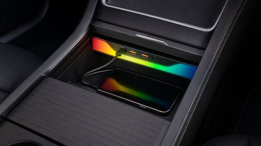 Four-port RGB USB hub with two USB-A and two USB-C ports installed in an older Tesla Model 3 or Model Y center console