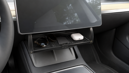 Tesheer hidden under-screen storage box open beneath a fixed Tesla Model 3 factory display with sunglasses, key card, and earbuds case