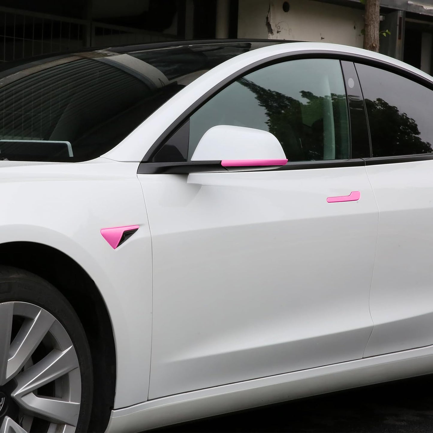 Tesla Model Y Juniper with fuchsia door handle wraps and camera covers installed