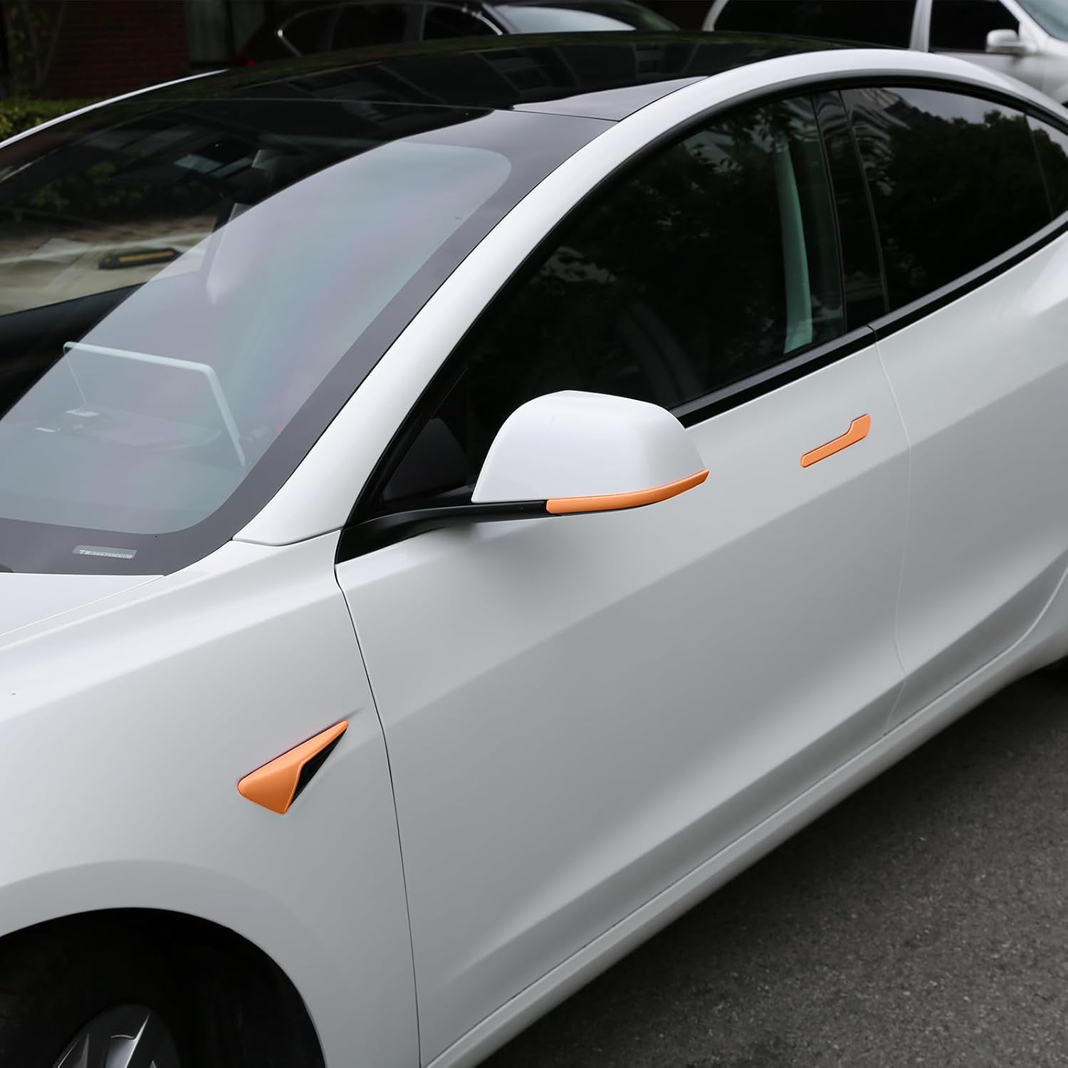 Orange Tesheer accessories on Pearl White Tesla Model 3 Highland