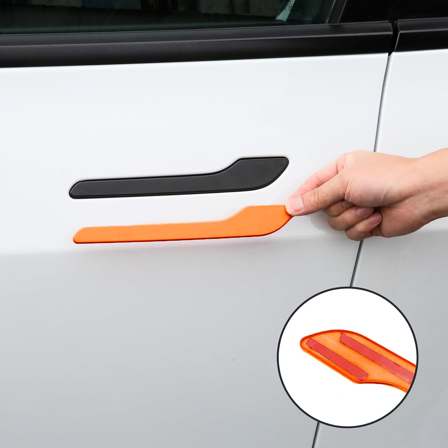 Tesla Model 3 Highland with orange door handle wraps and camera covers installed