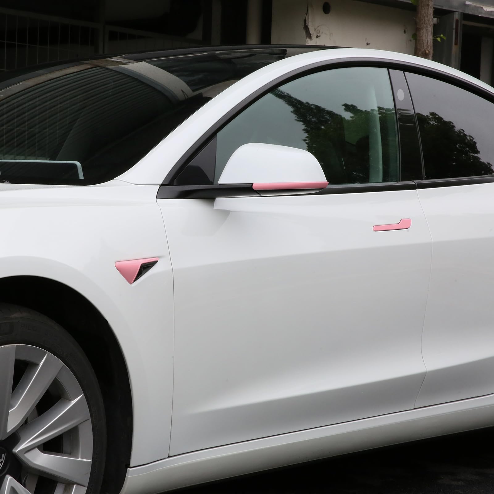 Tesla Model 3 Highland with pink door handle covers and camera covers installed